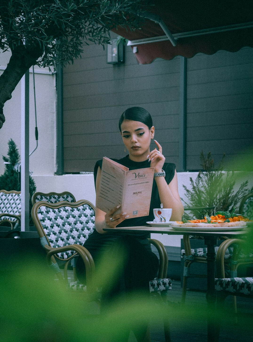 person reading newspaper in cafe